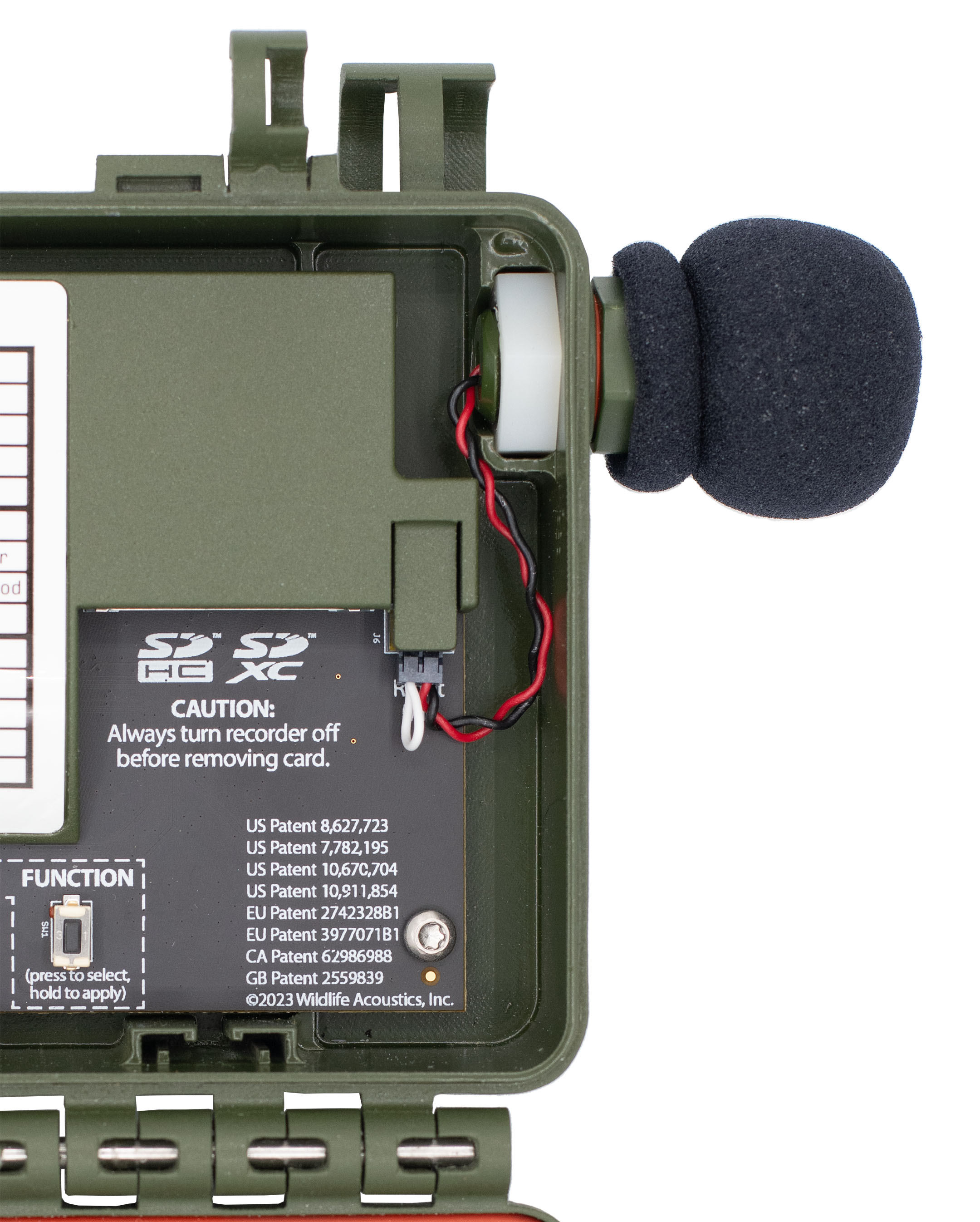 The wires exit the microphone stub and are tucked down and to the right, between the slot that holds the hex bolt and the plastic shroud that protects the Right Microphone port. The wires are looped down and to the left to plug into the Right Microphone port.