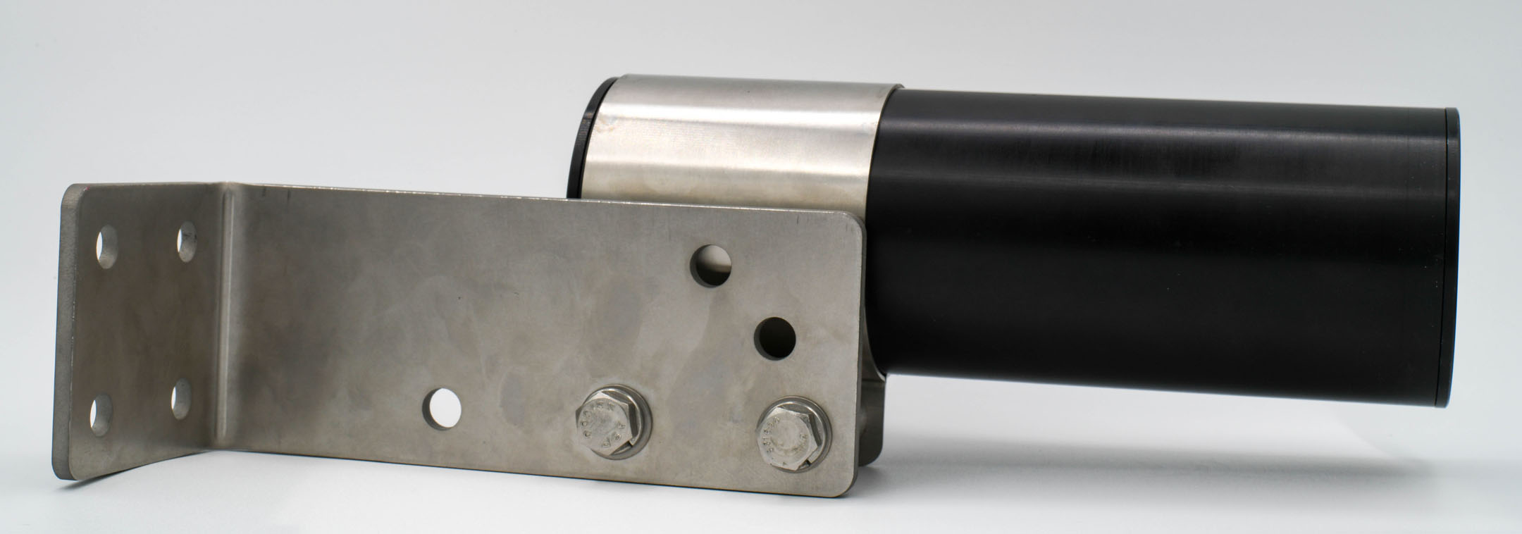 The bracket juts outwards horizontally from a wall. The microphone extends further outwards in the same direction.